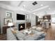 Open concept living room with modern fireplace, recessed lighting, and a kitchen at 1164 Sugarloaf Ln, Erie, CO 80516