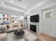 The living room has a modern fireplace, large windows, and a neutral color palette at 1164 Sugarloaf Ln, Erie, CO 80516