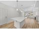 Open floor plan featuring a kitchen island and living room with lots of natural light at 1164 Sugarloaf Ln, Erie, CO 80516