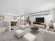 Spacious living room with ample natural light, modern furnishings, and a pool table at 1164 Sugarloaf Ln, Erie, CO 80516