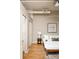 Cozy bedroom boasts hardwood floors, closet and modern decor at 1555 California St # 609, Denver, CO 80202