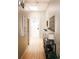 Light and airy hallway with wood floors and stylish decor, including artwork and console table at 1555 California St # 609, Denver, CO 80202