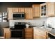 Well-equipped kitchen with stainless steel appliances, ample counter space, and light wood cabinetry at 1555 California St # 609, Denver, CO 80202