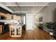 Bright kitchen with stainless steel appliances, granite countertops, a functional island, and hardwood floors at 1555 California St # 609, Denver, CO 80202