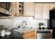 Functional kitchen featuring granite countertops, stainless steel dishwasher, and ample cabinet storage at 1555 California St # 609, Denver, CO 80202