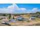 Aerial view of property, showing the house, outbuilding, lawns, fencing, and beautiful mountain views at 16029 W 75Th Pl, Arvada, CO 80007