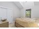 Cozy bedroom with a vaulted ceiling, neutral paint and decor, a window, and double door closet at 16029 W 75Th Pl, Arvada, CO 80007