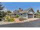 Charming home featuring a large attached garage, a lovely lawn, and mature landscaping at 16029 W 75Th Pl, Arvada, CO 80007