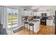 Modern kitchen featuring granite countertops, stainless steel appliances, and adjacent outdoor access at 16029 W 75Th Pl, Arvada, CO 80007