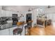 Modern kitchen featuring granite countertops, stainless steel appliances, and bar stool seating at 16029 W 75Th Pl, Arvada, CO 80007