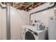 Functional laundry room includes a washer, dryer, utility sink, and storage space at 16029 W 75Th Pl, Arvada, CO 80007