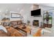 Inviting living room showcasing a stone fireplace and ample natural light at 16029 W 75Th Pl, Arvada, CO 80007