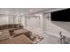 This spacious living room has a plush sectional, recessed lighting, and several doorways at 16029 W 75Th Pl, Arvada, CO 80007