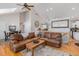 Cozy living room adjacent to dining area, featuring hardwood floors and comfortable seating at 16029 W 75Th Pl, Arvada, CO 80007