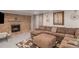 Inviting Gathering room featuring a brick fireplace, plush sectional, and neutral decor at 16029 W 75Th Pl, Arvada, CO 80007