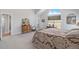 Bright bedroom with patterned bedspread, antique dresser, and views at 16029 W 75Th Pl, Arvada, CO 80007