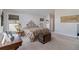Bedroom with a vintage trunk at the foot of the bed and windows with shades at 16029 W 75Th Pl, Arvada, CO 80007