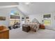 Spacious main bedroom featuring a vaulted ceiling, large windows, and patterned bedspread at 16029 W 75Th Pl, Arvada, CO 80007