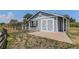 Exterior of a one-story outbuilding features painted siding, a barn door, and an adjacent fenced pen at 16029 W 75Th Pl, Arvada, CO 80007