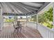 Comfortable front porch with wooden floors, table, chairs, and a lovely view of the lawn at 16029 W 75Th Pl, Arvada, CO 80007