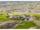 Aerial view of the community clubhouse, golf course, and surrounding neighborhood at 23427 Song Bird Hills Pl, Parker, CO 80138