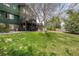 Spacious backyard with a wooden deck, patio, fire pit, and mature trees for shade at 23427 Song Bird Hills Pl, Parker, CO 80138