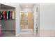 Bathroom featuring a glass-enclosed shower and a walk-in closet with ample storage space at 23427 Song Bird Hills Pl, Parker, CO 80138