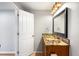 Charming powder room with granite countertop, decorative mirror, and classic design at 23427 Song Bird Hills Pl, Parker, CO 80138