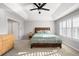 Cozy bedroom with tray ceilings, carpeted floor, and a wooden bed frame at 23427 Song Bird Hills Pl, Parker, CO 80138