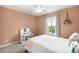 Bright bedroom features a plush bed, vanity, and a window view at 23427 Song Bird Hills Pl, Parker, CO 80138