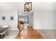 Inviting foyer with hardwood floors, staircase, and views into the living room showcasing natural light at 23427 Song Bird Hills Pl, Parker, CO 80138