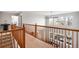 Open hallway with wood railings and a view to the living room at 23427 Song Bird Hills Pl, Parker, CO 80138