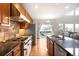 Modern kitchen boasting stainless steel appliances, custom cabinets, and granite countertops at 23427 Song Bird Hills Pl, Parker, CO 80138