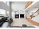 Spacious living room featuring high ceilings, fireplace, staircase, and a comfortable leather sectional at 23427 Song Bird Hills Pl, Parker, CO 80138