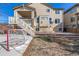 A house's backyard with a set of stairs leading to a porch and an area for playing hockey at 15310 E 108Th Way, Commerce City, CO 80022