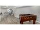 Spacious basement featuring light grey floors and a foosball table at 15310 E 108Th Way, Commerce City, CO 80022