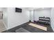 Basement gym space featuring rubber flooring, weights, yoga mats, and mounted TV at 15310 E 108Th Way, Commerce City, CO 80022