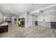 Spacious finished basement with gray wood floors, game area, and wet bar with two wine coolers at 15310 E 108Th Way, Commerce City, CO 80022