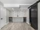 Stylish basement wet bar with gray cabinets, geometric backsplash, undermount sink, and dual wine coolers at 15310 E 108Th Way, Commerce City, CO 80022