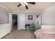 Bedroom with lilac walls, white trim, a neutral carpet, and a view of the landing outside the door at 15310 E 108Th Way, Commerce City, CO 80022