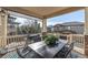Covered deck with outdoor dining area, grill, and views of the surrounding neighborhood at 15310 E 108Th Way, Commerce City, CO 80022