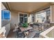 Covered patio with dining table, grill, and views of the outdoor living space and community at 15310 E 108Th Way, Commerce City, CO 80022