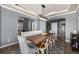 Stylish dining room features a gray rug, modern chandelier, and access to other rooms at 15310 E 108Th Way, Commerce City, CO 80022