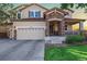 Charming two-story home with a stone-accented entrance and well-maintained lawn at 15310 E 108Th Way, Commerce City, CO 80022