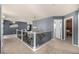 Landing with wrought iron banister, dark grey walls, and modern chandelier at 15310 E 108Th Way, Commerce City, CO 80022