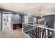 Landing featuring an integrated desk, dark grey walls, and wrought iron banister at 15310 E 108Th Way, Commerce City, CO 80022