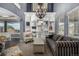 Elegant living room with high ceilings, built-in bookshelves, and stylish decor at 15310 E 108Th Way, Commerce City, CO 80022