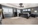 Elegant main bedroom features a tray ceiling, two windows, and neutral decor at 15310 E 108Th Way, Commerce City, CO 80022