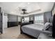 Elegant main bedroom features a tray ceiling, a fan, two windows, and neutral decor at 15310 E 108Th Way, Commerce City, CO 80022