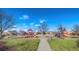 A playground with slides, swings, climbing structures, and a paved path at 15310 E 108Th Way, Commerce City, CO 80022